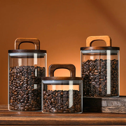 Premium Glass Coffee Canister With An Airtight Wooden Lid To Keep Your Daily Grind Fresh, showcasing coffee beans in three sizes.
