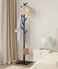 Freestanding Coat Rack With Stable Square Base 8 Hooks And 3 Adjustable Heights in bedroom, holding a hat, shirt, and bag.