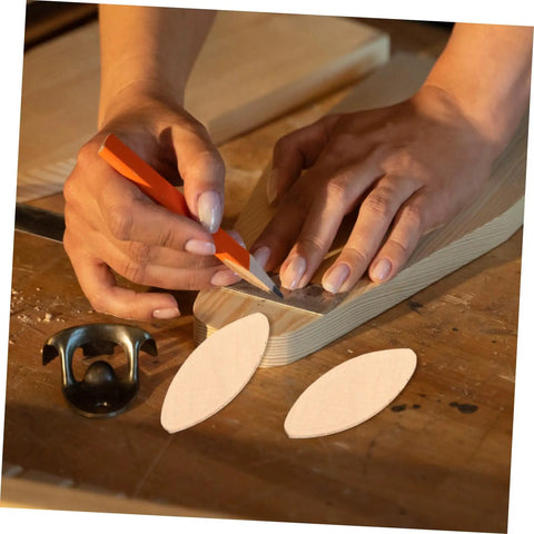 Premium 100 Pack Beech Wood Joiner Biscuits on workbench with hands marking slots for furniture framing.