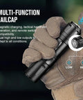 Gloved hand holding Ultra Compact Tactical Flashlight For Hunting And Outdoor Use, 1250 Lumens, showing multi-function tailcap.