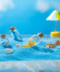 Rad Craft Supply Set Featuring 45 Mini Glass Potion Bottles With Tight Cork Stoppers And Durable Eye Hooks among beach sand with decorative items.