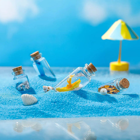 Rad Craft Supply Set Featuring 45 Mini Glass Potion Bottles With Tight Cork Stoppers And Durable Eye Hooks among beach sand with decorative items.
