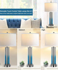 Set Of 2 Ombre Indigo Glass Table Lamps With USB Ports, LED Bulbs Included, Three Way Dimmable Light, shown in different brightness levels