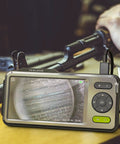 NTG500 Rifle Borescope With Five Inch Monitor And Forty Five Inch Flexible Probe For Close Focus Barrel Inspection Cleaning Checks And Firearm Barrel Diagnostics, shown inspecting rifle barrel