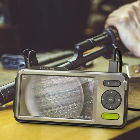 NTG500 Rifle Borescope With Five Inch Monitor And Forty Five Inch Flexible Probe For Close Focus Barrel Inspection Cleaning Checks And Firearm Barrel Diagnostics, shown inspecting rifle barrel