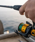 Angler using Spinfisher VII 3500 Saltwater Spinning Reel With IPX5 Seal Tough Aluminum Spool Left Right Handle Position HT-100