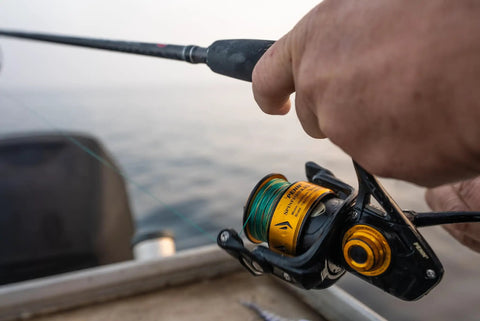 Angler using Spinfisher VII 3500 Saltwater Spinning Reel With IPX5 Seal Tough Aluminum Spool Left Right Handle Position HT-100