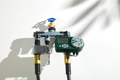 Automatic Yard Watering System With Four Station Sprinkler Setup on a wall, featuring large digital display and easy dial controls.