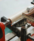 4-prong spur drive center on wood lathe driving a pale wood blank; 1-inch diameter, 2MT.