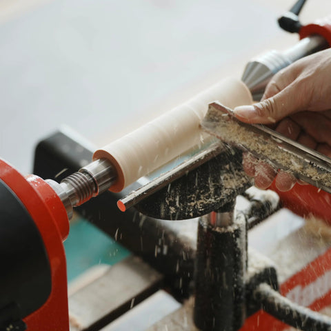4-prong spur drive center on wood lathe driving a pale wood blank; 1-inch diameter, 2MT.