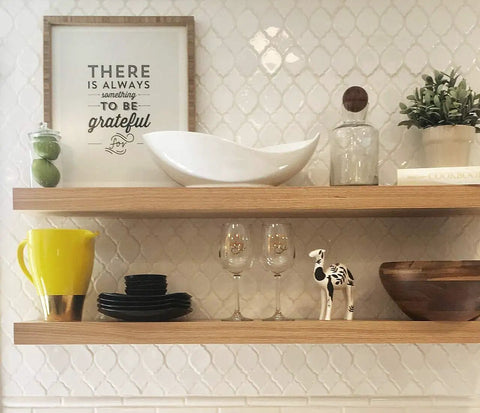 Wooden shelves with decor items and framed quote, showing wood grain, suitable for White Oak Wood Veneer Edgebanding projects.