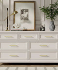 White dresser with Brushed Gold Cabinet Pulls 10 Pack, 5 Inch Hole Center Drawer Handles, shown in home setting.