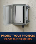 Outdoor Weatherproof Junction Box With Hinged Cover In Lightweight Polycarbonate NHWE M, NEMA 4X Rated Electrical Cabinet For Outdoor Wiring, Plugs, And Cables, Includes Cable Glands, Mounting Plate, UV And Rain Shield. Open wall-mounted box with router inside