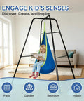 Child reading in Kid Friendly Sensory Pod Swing Set With Heavy Duty Frame For Indoor Outdoor Play, blue hammock.