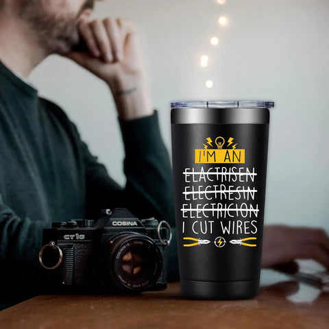 20oz Electrician Tumbler Gift For Men Hilarious On Site Gear No Brainer Gift For Dad Husband Boyfriend Or Co Worker Electrical Engineer Gift Christmas Birthday Fathers Day with humorous text on table next to camera.