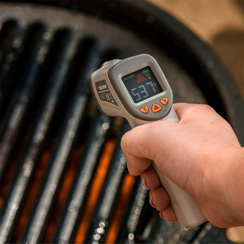 No Touch Infrared Thermometer For Cooking And BBQ Laser Temperature Gun With Digital Display held over a hot grill