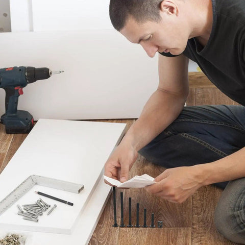 Man selecting pieces from 141 Piece Replacement Screws Kit With Aluminum Alloy Bolts And Nuts For Chairs Beds Cribs And Bunk Beds