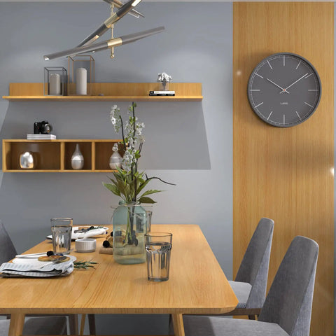 Dining area with wooden table, chairs, wall shelves, and a clock. Wall showcases oak finish similar to Dope Wood Grain Peel And Stick Wallpaper.