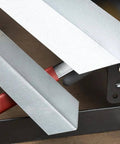 Close-up of MB48B 48 Inch Pan Style Mini Brake forming 135-degree bends in 22 gauge galvanized steel on a bench