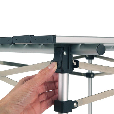 Close-up of hand assembling the Outdoor Folding Table with Aluminum Slat Top and Snap Together Design Seats Four Carry Bag Included.