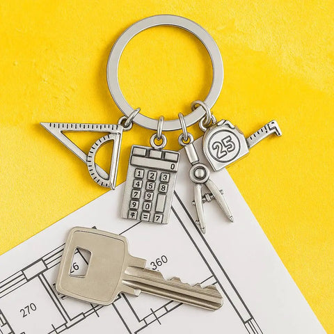 Engineer Keychain Set With Geometry Charm And Measuring Tools, Triangle Ruler Mini Calculator Compass And Tape Measure on blueprint