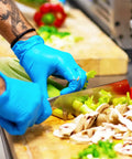 Person wearing Large Nitrile Gloves Powder Free Latex Free 4 Mil 100 Count Exam Disposable Non Sterile chopping vegetables on board