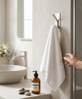 Insane Grip No Drill Towel Hooks Six Pack Silver Rust Proof Heavy Duty Bathroom Wall Mount with towel hanging in bathroom.