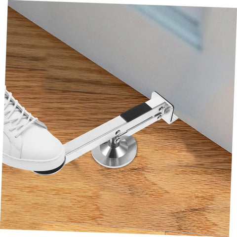 Multi Function Door Lifter Tool For Drywall Panels And Door Installation Help, shown lifting door with foot lever on wood floor.