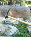 Steel Gardening Pickaxe Handle For Efficient Weeding And Soil Digging In Vegetable And Flower Gardens Built As A Workhorse For Home Use With Comfort Grip And Durable Non Rust Design on Rocks