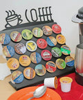Space Saving K Cup Pod Holder For Countertop Holds 24 Coffee Pods In A Sleek Black Metal Display Stand Durable And Grab And Go Coffee Organizer Rack For K Cups showcasing full capacity of pods near a coffee maker.