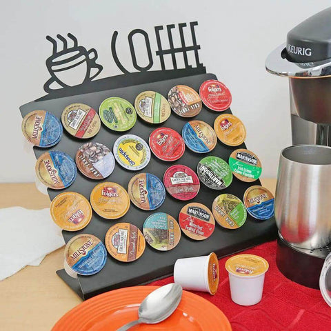 Space Saving K Cup Pod Holder For Countertop Holds 24 Coffee Pods In A Sleek Black Metal Display Stand Durable And Grab And Go Coffee Organizer Rack For K Cups showcasing full capacity of pods near a coffee maker.