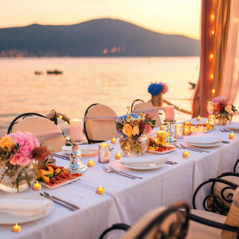 Outdoor wedding table setting with Battery Powered Flickering Flameless Candles With Warm Yellow Glow, flowers, and lake view