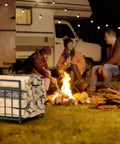 15.5 Inch Compact Metal Firewood Rack with Built-In Fire Blower near campfire and RV, ideal for storing wood outdoors