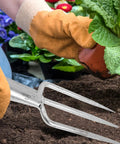 Gardener using Three-Prong Fish Fork Beefed-Up Heavy Duty Steel Garden Tool For Fishing And Harvesting Ergonomic Handle Versatile Outdoor Fork.