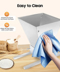 Manual Grain Mill With Adjustable Roller Gap For Wheat Berries, easy to clean stainless steel housing being wiped with cloth
