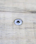 Close-up of Dead Nuts Corrosion Resistant Stainless Deck Screw, square drive, installed in wood surface.