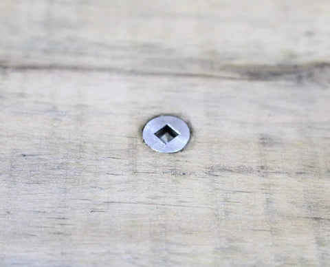 Close-up of Dead Nuts Corrosion Resistant Stainless Deck Screw, square drive, installed in wood surface.