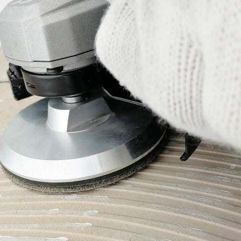 Close-up of Aluminum Backer Pad Set 4 Inch Hook and Loop Backing Pads 5/8-11 Arbor attached to sander in use