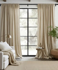 Living room with beige curtains hanging from a 36-91 Inch Black Adjustable Curtain Rod 1 Inch Heavy Duty Telescoping Drapery Pole For Windows Modern Decorative Window Treatment No Tools Required Quick And Easy Installation over large window.