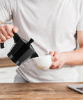 Pouring coffee with 6 Cup Electric Moka Pot Espresso Maker 300ml Portable Aluminum Coffee Brewer Detachable Base Travel Friendly Black