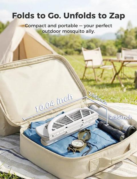 Foldable Electric Fly Swatter Racket With 4000V High Voltage, folded in a suitcase with camping gear, showcasing portability.
