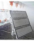 Killer Brightness 300W LED Outdoor Flood Light Heavy Duty IP66 Waterproof being tested with water spray for durability.