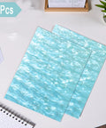 Pearlescent Cast Acrylic Sheets 1/8 Inch Thick In Aqua With Ocean Ripple Pattern For DIY Crafts And Home Decor 2-pack on desk