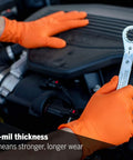 8 Mil Orange Diamond Textured Nitrile Gloves For Heavy Duty Auto And Industrial Tasks 100 Count Extra Size worn while using a wrench on an engine.