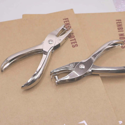 Dual Hole Punch Set With One Quarter Inch And One Eighth Inch Holes on brown paper, stainless steel ergonomic handheld punch
