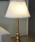 Spyglass Table Lamp With Antique Brass Finish Dope Retro Modern Classic Vibe Linen Shade 30.5 Inch Tall on a side table