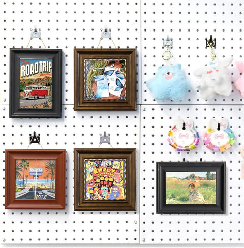 20 Pack Black Pegboard Picture Hangers for One Eighth and One Quarter Inch Boards with U Shape Prong Design used on wall