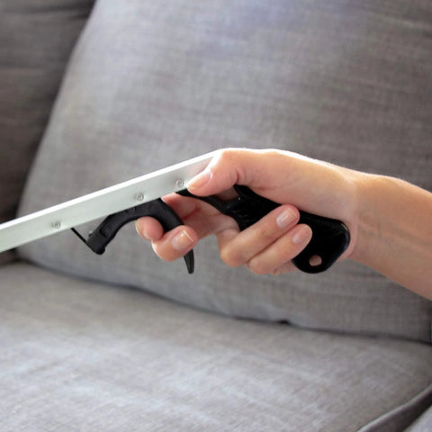 DMI reacher grabber tool with 32-inch silver shaft and black trigger-grip handle held in hand.