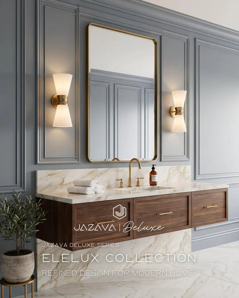 JAZAVA 2-Light Up Down Wall Sconce, Frosted Pleated Glass, Pale Brass in an elegant bathroom setting with a gold-framed mirror.