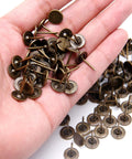 Solid Bronze Flat Head Upholstery Tacks 100 Pack Rustproof Trim Nails For Furniture Refreshes held in hand showing their size and design.
